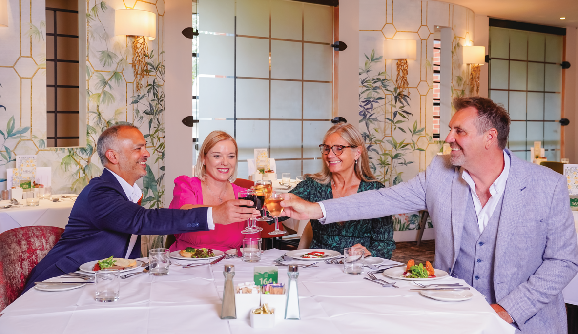 Two modelling couples toasting over dinner at Potters Resort restaurant